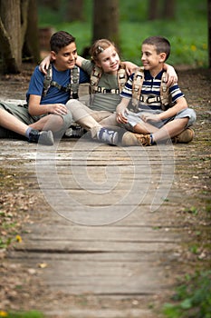 Happy childs in green forest playing,concept of kids vacations a