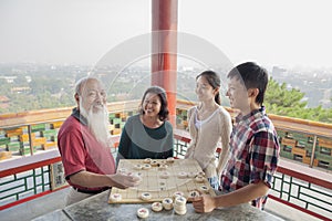 Happy Chinese Family Playing Chinese Chess (Xiang Qi)