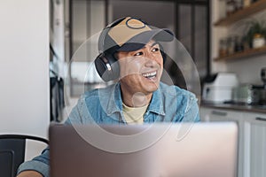 Happy chinese man during an online meeting at home