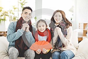 Happy chinese new year. asian family showing congratulation gesture at home