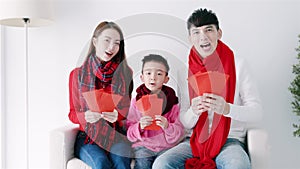 happy chinese new year. asian family showing congratulation gesture at home