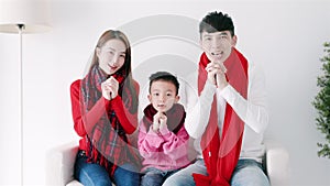 happy chinese new year. asian family showing congratulation gesture at home