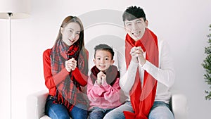 happy chinese new year. asian family showing congratulation gesture at home