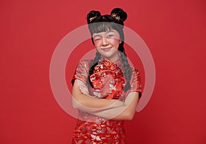 Happy Chinese new year. children asian girl wearing traditional cheongsam qipao dress with gesture smile and happy chinese new