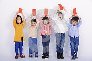 Happy chinese new year. excited kids showing Red envelopes for lucky