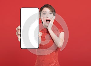 Happy chinese new year. suprised young Woman showing blank smart phone screen