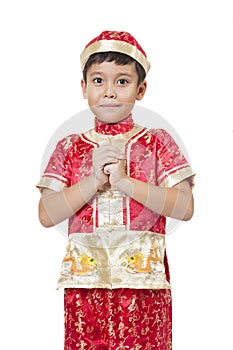 Happy Chinese new year.Young Asian boy with gesture of congratulation