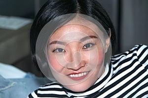 Happy chinese woman smiling inside