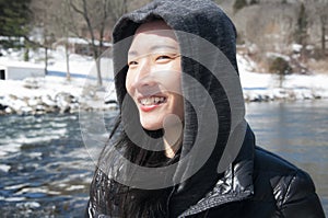 Happy Chinese woman traveling in the united states new england winter