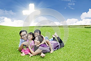 Happy Christian family on the grass