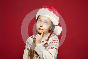 Happy Christmas child dreaming on red background, Christmas and New Year gift concept