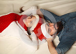 Happy Christmas couple resting at home