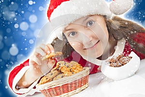 Happy Christmas girl eating Christmas cookies