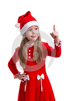 Happy christmas girl with a pointing finger up, wearing a santa hat isolated over a white background