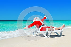 Happy Christmas Santa Claus on white beach bed at ocean beach