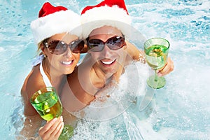 Happy Christmas santa couple in jacuzzi.