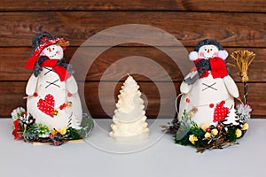 Happy Christmas snowman. Christmas decoration on a wooden background. Greeting card. Xmas decoration.