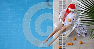 Happy Christmas Woman with Cocktail at the Pool