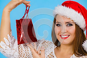 Happy Christmas woman holds gift bag