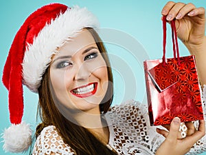 Happy Christmas woman holds gift bag