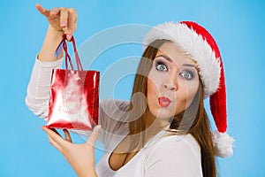 Happy Christmas woman holds gift bag