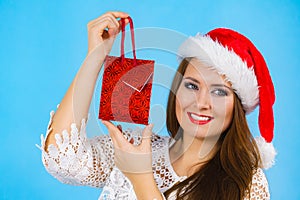 Happy Christmas woman holds gift bag