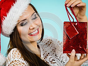 Happy Christmas woman holds gift bag