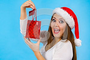 Happy Christmas woman holds gift bag