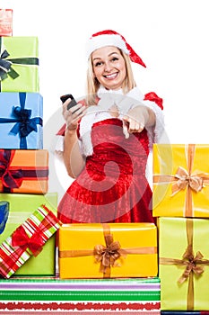 Happy Christmas woman with phone pointing