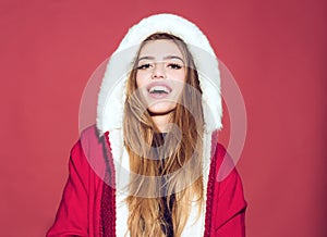 Happy christmas woman in santa claus hat with hood on red background, happy girl at new year party celebration.