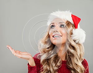 Happy Christmas Woman in Santa Hat Showing Empty Copy Space