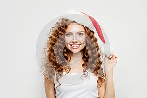 Happy Christmas woman in Santa hat smiling on white background. Christmas and New Year party
