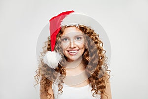 Happy Christmas woman in Santa hat smiling on white background. Christmas and New Year party