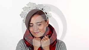 Happy Christmas woman in snowflakes headband wearing winter scarf