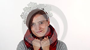 Happy Christmas woman in snowflakes headband wearing winter scarf