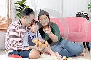 Happy chubby Asian family. Father and mother playing with little girl daughter in living room. Parents spending time together with