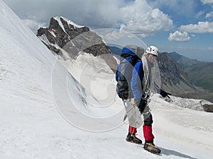 Happy climber on snow alpinist route