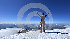 Happy climber on the top of Mount Kazbek. Climbing Kazbek from the north, from Russia