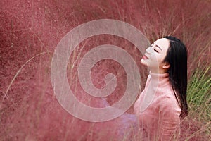 Happy closed eyes Asian Chinese woman girl feel freedom sweet dream pray flower field autumn fall park grass lawn hope nature