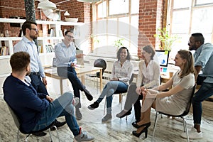 Happy coach laughing at employee joke at briefing photo