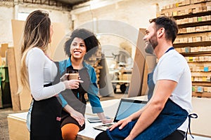 Happy colleagues smiling and talking during break at warehouse