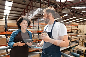 Happy colleagues talking during break at warehouse