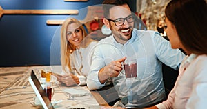 Happy colleagues from work socializing in restaurant