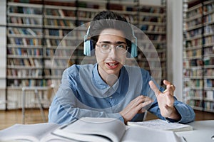 Happy college freshman in glasses and headphones head shot portrait