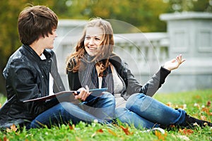 Happy college students on campus lawn outdoors