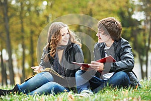 Happy college students on campus lawn outdoors