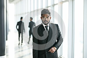 Happy company leader CEO boss executive standing in front of company building in office hall