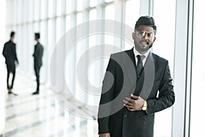 Happy company leader CEO boss executive standing in front of company building in office hall