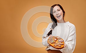 Happy confectioner woman holding wooden tray with gingerbread cookies.