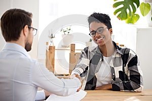 Happy confident african applicant shaking hand of hr getting hired